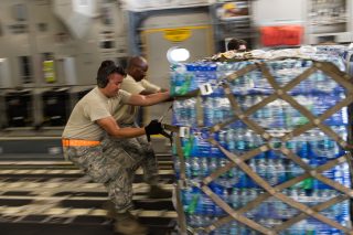 U.S. Air Force Senior Airman Alexander Cole, left, 136th Airlift Wing, Texas Air National Guard and Master Sgt. James Jones, Tennesse Air National Guard, offload a water pallet from a Travis Air Force Base, Calif., C-17 Globemaster III aircraft, Sept. 23, 2017 at St. Croix, U.S. Virgin Islands. The C-17 delivered 105,000 pounds and 18 pallets of water and MREs to the island after it had sustained damage from Hurricane Maria. (U.S. Air Force Photo by Master Sgt. Joseph Swafford)