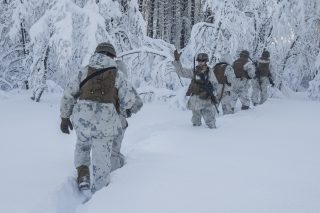 A U.S. Marine with Marine Rotational Force-Europe 20.1, Marine Forces Europe and Africa, signals Marines to hurry during exercise Snow Panzer in Setermoen, Norway, Feb. 25, 2020. This exercise was used as preparation for Exercise Cold Response during which multiple NATO allies and partners will be participating. MRF-E focuses on regional engagements throughout Europe by conducting various exercises, arctic cold-weather and mountain-warfare training, and military-to-military engagements, which enhance overall interoperability of the U.S. Marine Corps with allies and partners. (U.S. Marine Corps photo by Lance Cpl. Nathaniel Q. Hamilton)